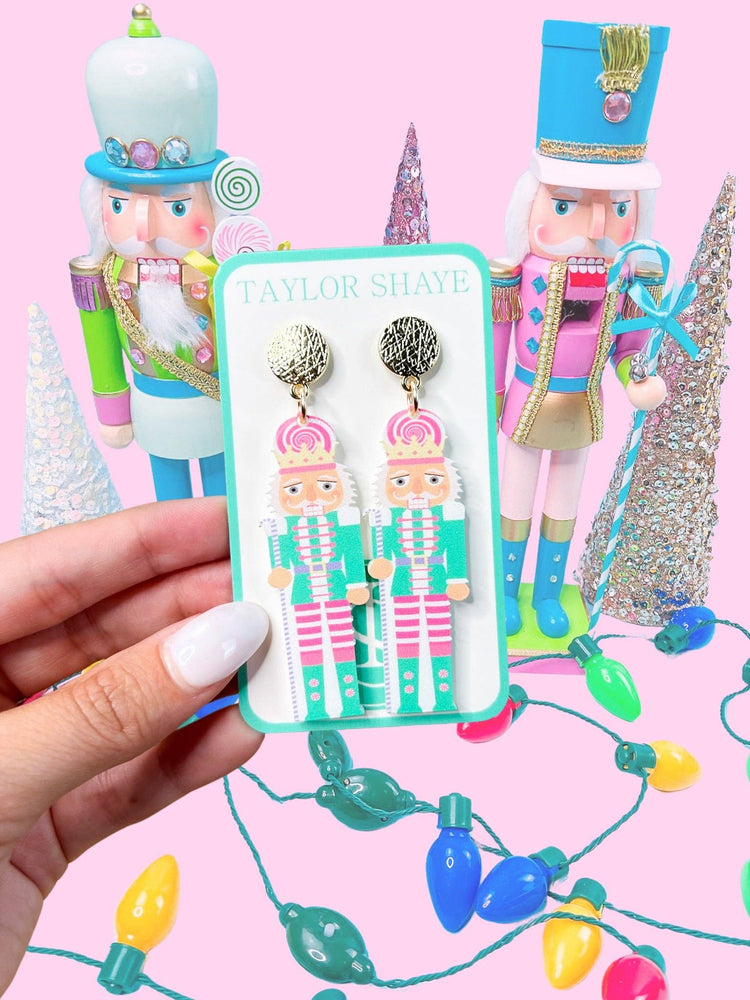 Heel Yeah Boutique Taylor Shaye Designs Candyland nutcracker dangle earrings with pink and teal festive details.