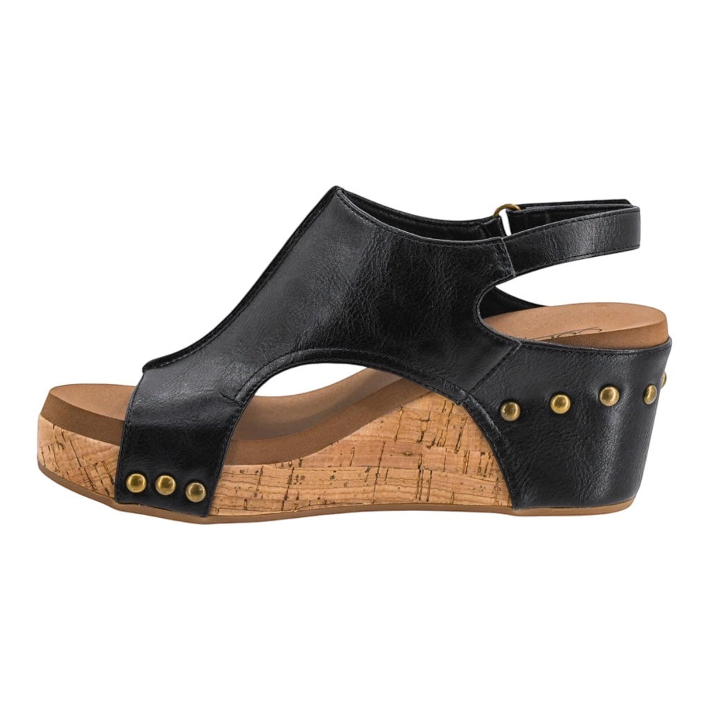 Heel Yeah Boutique Carly wedge sandal in black with a cork-style platform, gold stud accents, and a slingback strap.