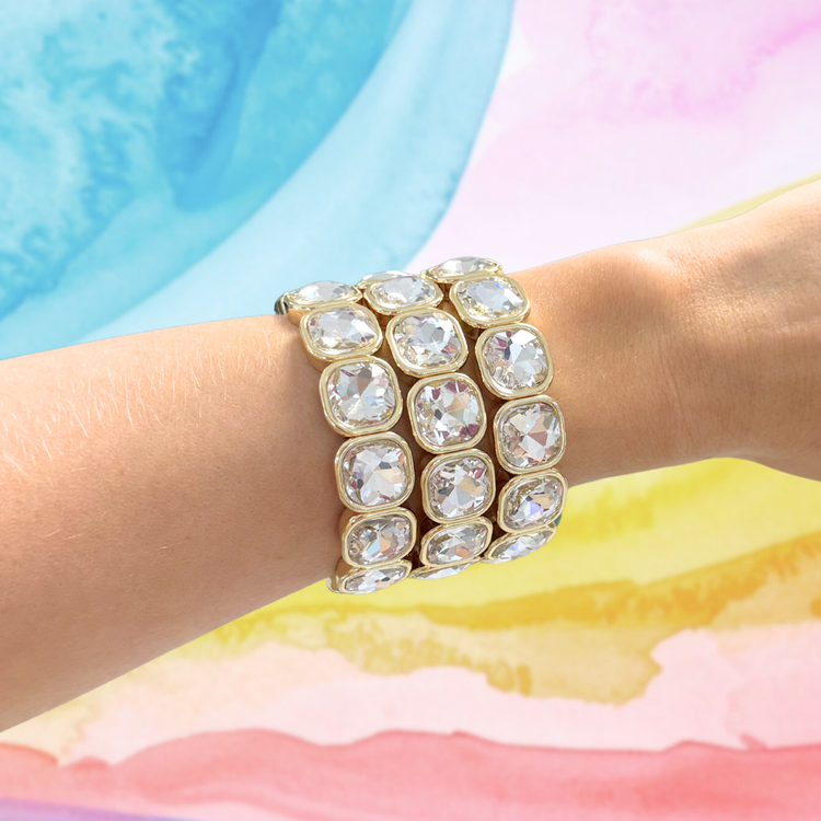 Heel Yeah Boutique Frankie bracelet featuring clear cushion-cut crystals set in gold on a woman's wrist
