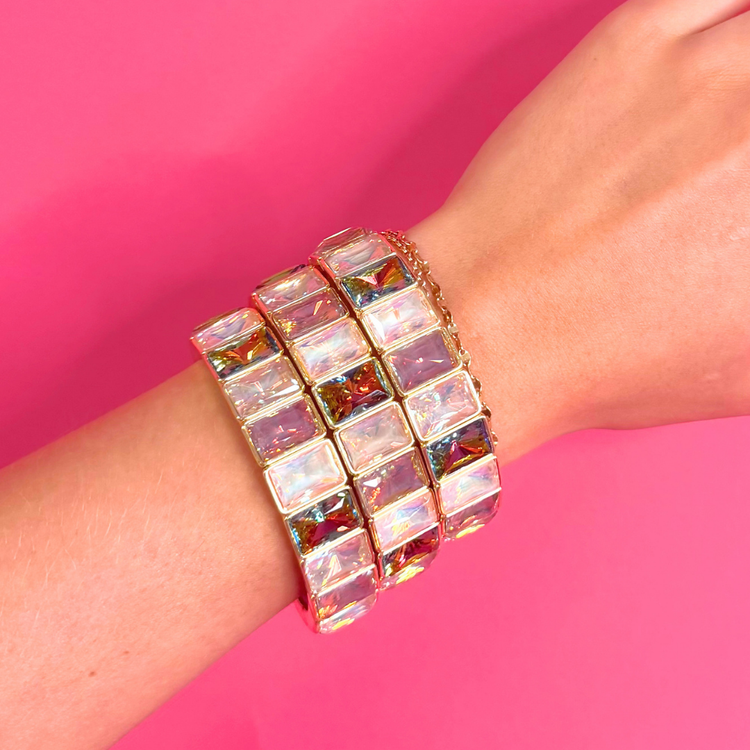 Heel Yeah Boutique Misty Bracelet featuring iridescent rectangular crystals on a gold-tone bangle worn on a wrist.