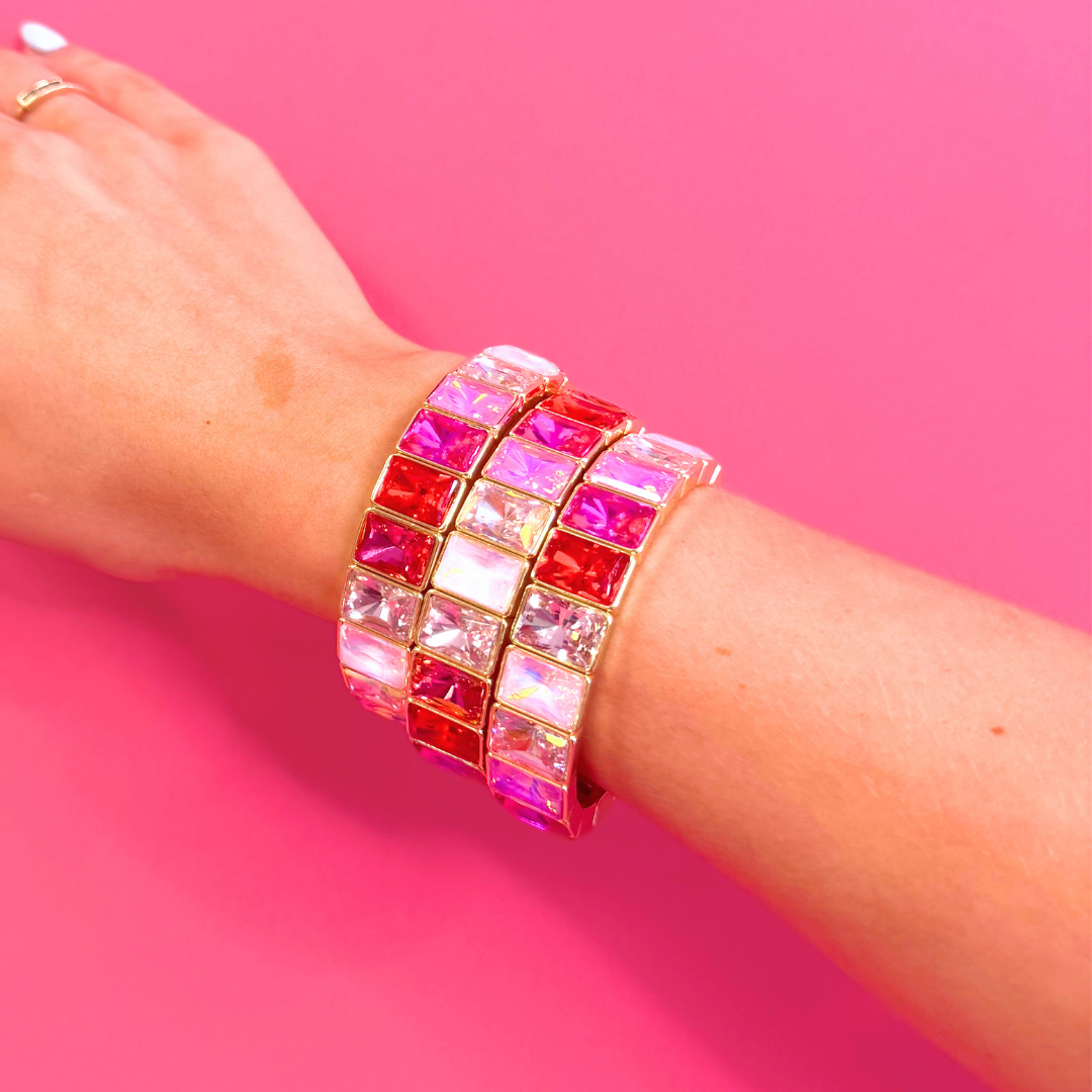 Heel Yeah Boutique Misty bangle bracelet featuring stacked pink and iridescent rectangular crystals on a wrist.