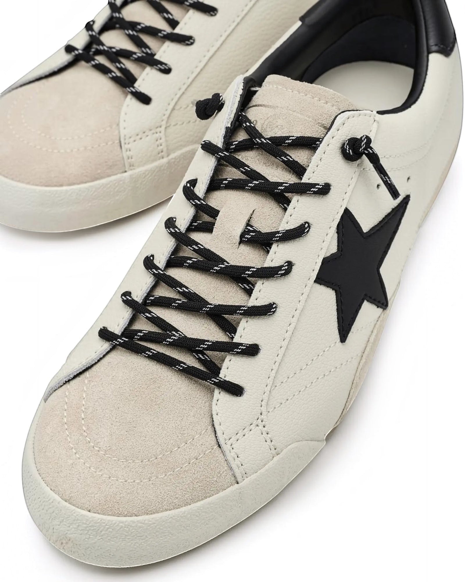 Heel Yeah Boutique Vintage Havana Legend sneakers in off-white leather and suede with a black star and slip-on laces.
